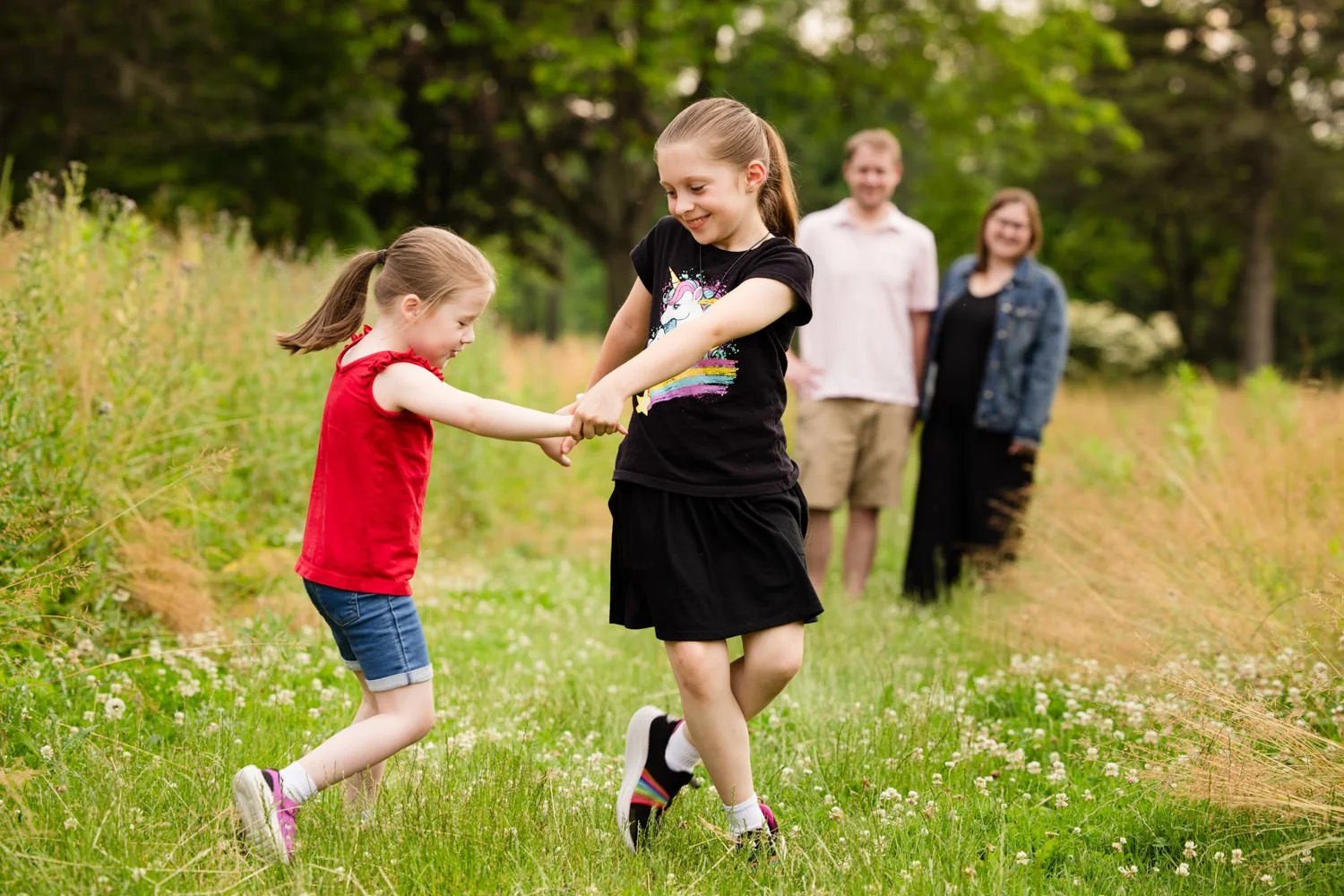 Two girls playing with rope during family pictures at Penfield NY park