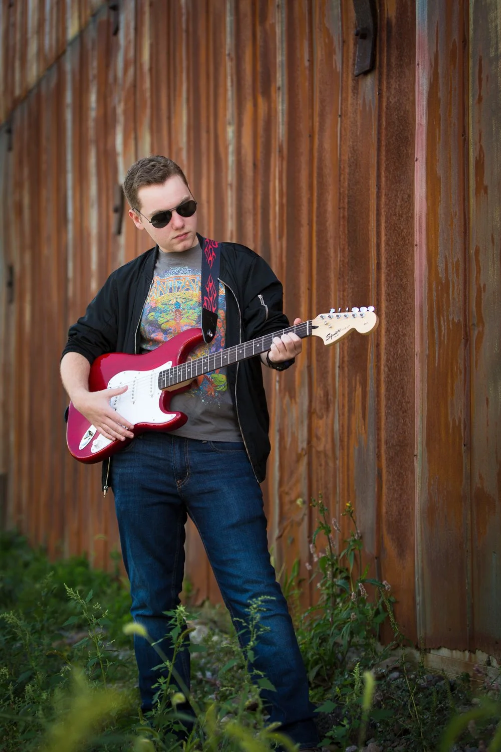 High school senior playing electric guitar during senior pictures at Schoen Place Pittsford NY