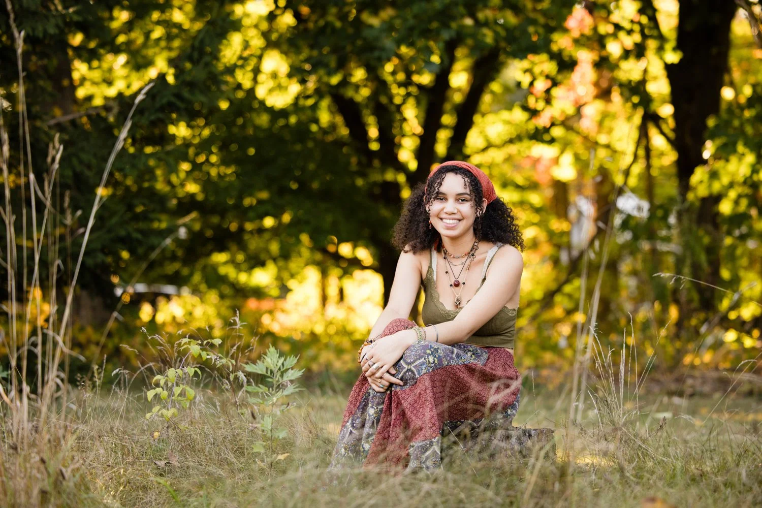 Senior photo session in Rochester NY capturing curly haired senior in natural outdoor setting