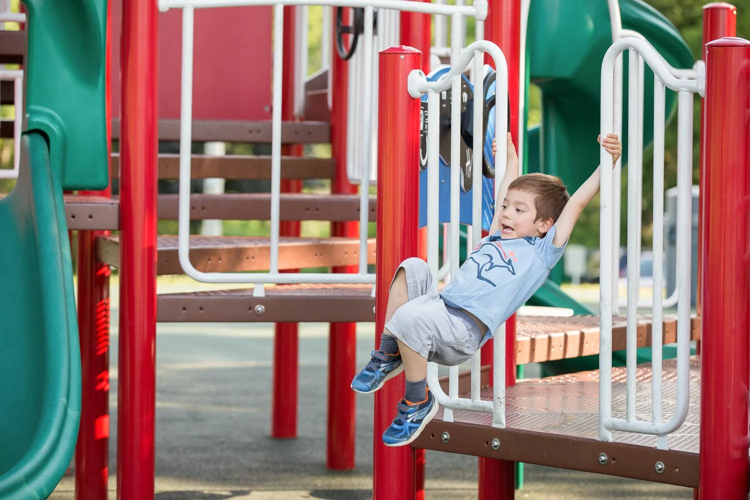 Candid family pictures at Egypt Park in Fairport NY featuring boy playing on playground