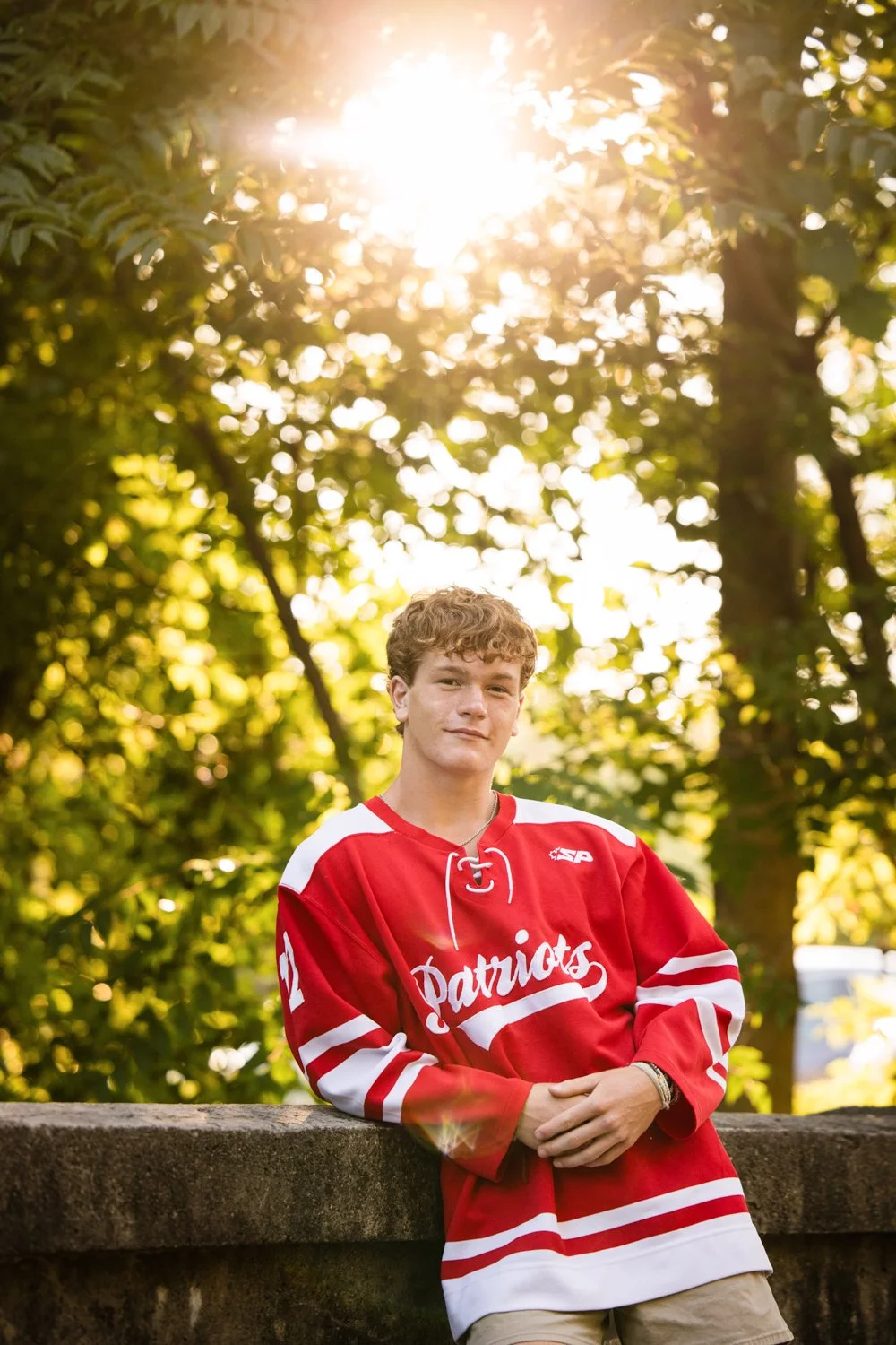 Linear Park Rochester NY senior photo session capturing high school hockey player outdoors
