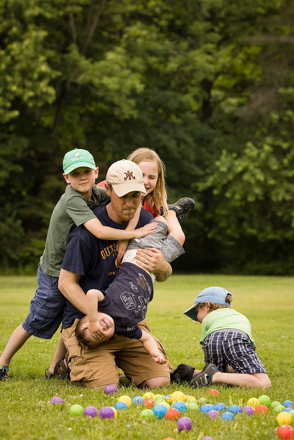 Candid family pictures at Linear Park in Penfield NY featuring dad playing with kids