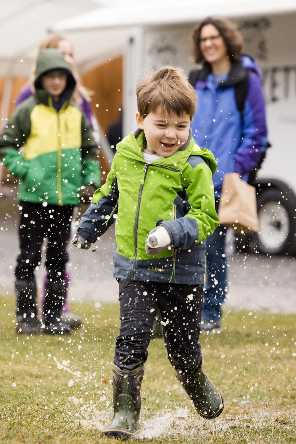 Candid family pictures at Kettle Ridge in Victor NY featuring child running in the rain