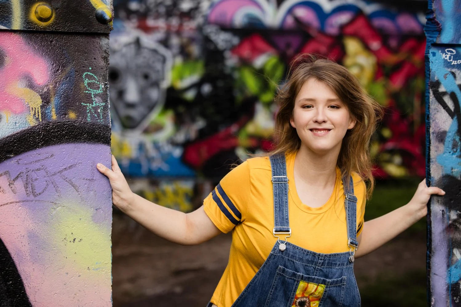 Senior pictures at Cobbs Hill in Rochester NY featuring high school senior with graffiti backdrop