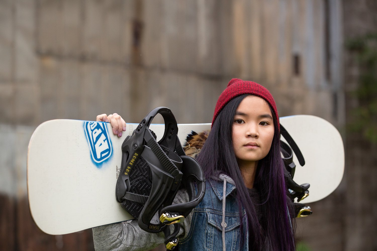 Fairport NY senior portrait session at Schoen Place with high school senior girl holding snowboard