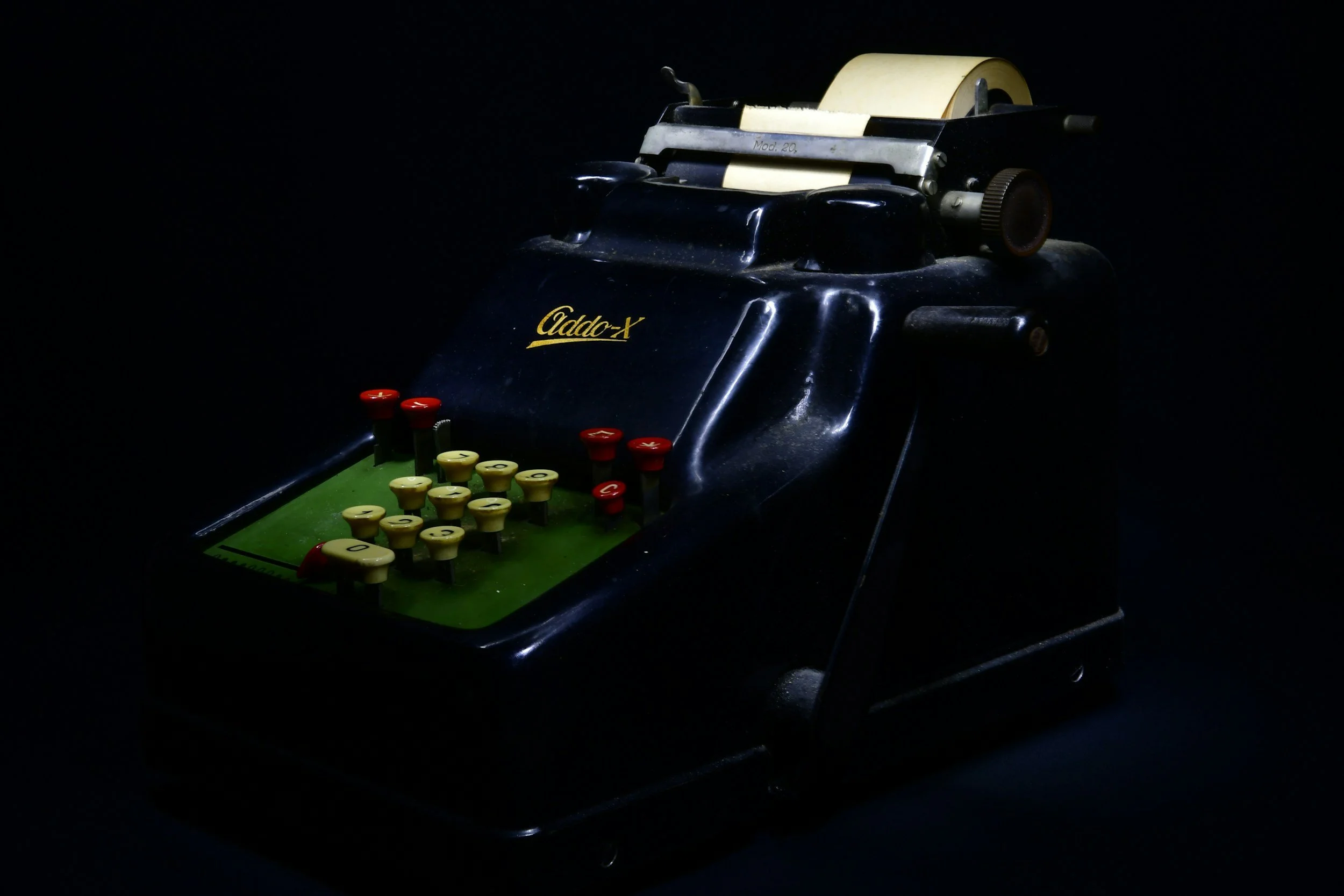 Vintage tabletop football game with miniature players and goal posts, dark background