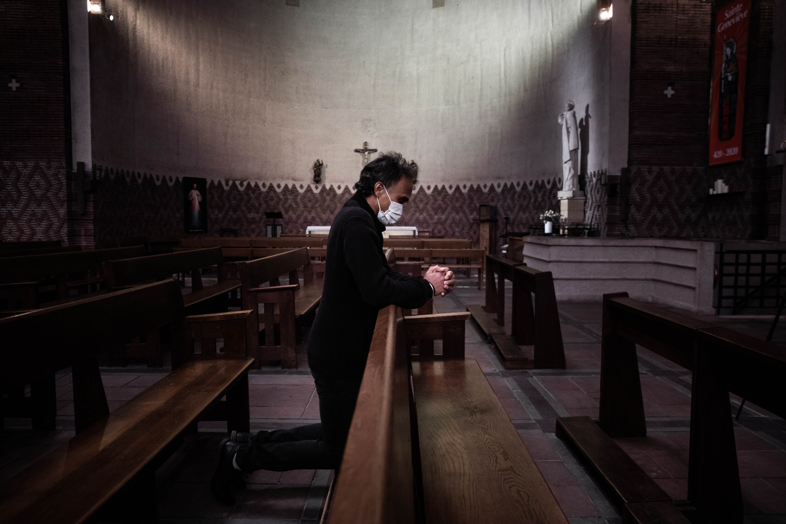   © Alexis Sciard / IP3; Paris, France, March 29, 2020  - A man wearing a sanitary mask prays inside Sainte Odile church during the Covid-19 epidemic.  