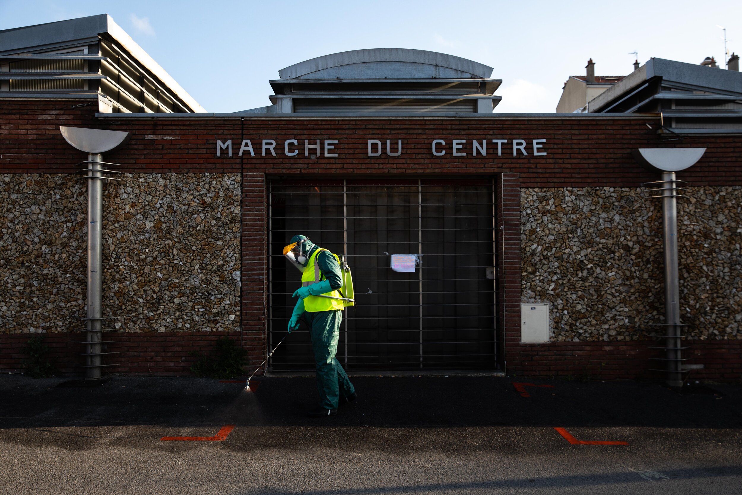   © Alexis Sciard / IP3; Neuilly Plaisance, France, March 31, 2020  - Man as he desinfects certain areas of the city centre with a chlorine solution in an attempt to stop the spread of the Coronavirus.  