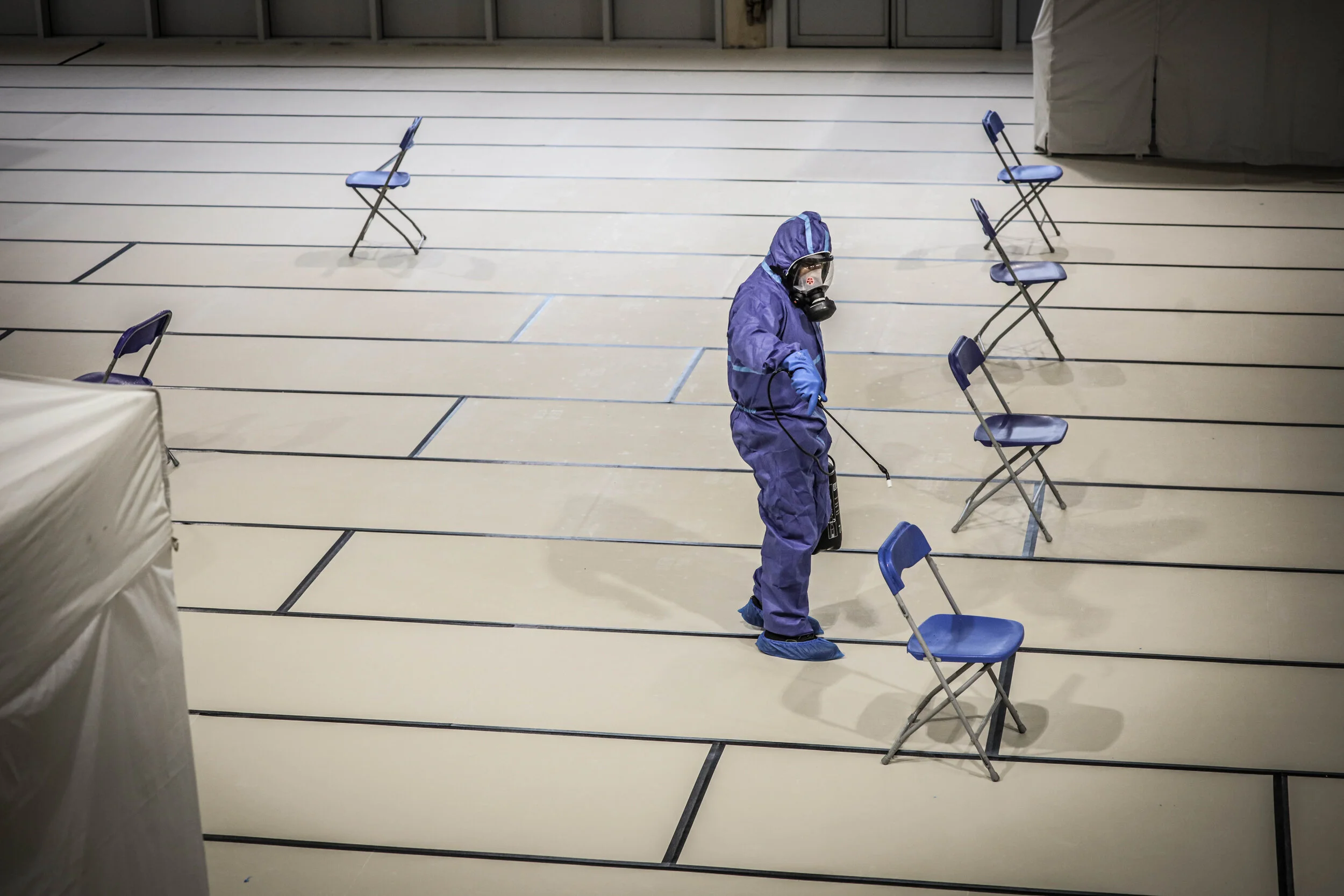   © Luc Nobout / IP3; Paris, France April 17, 2020 - Decontamination of a Covid center by an agent in waterproof clothing with decontaminating products.  