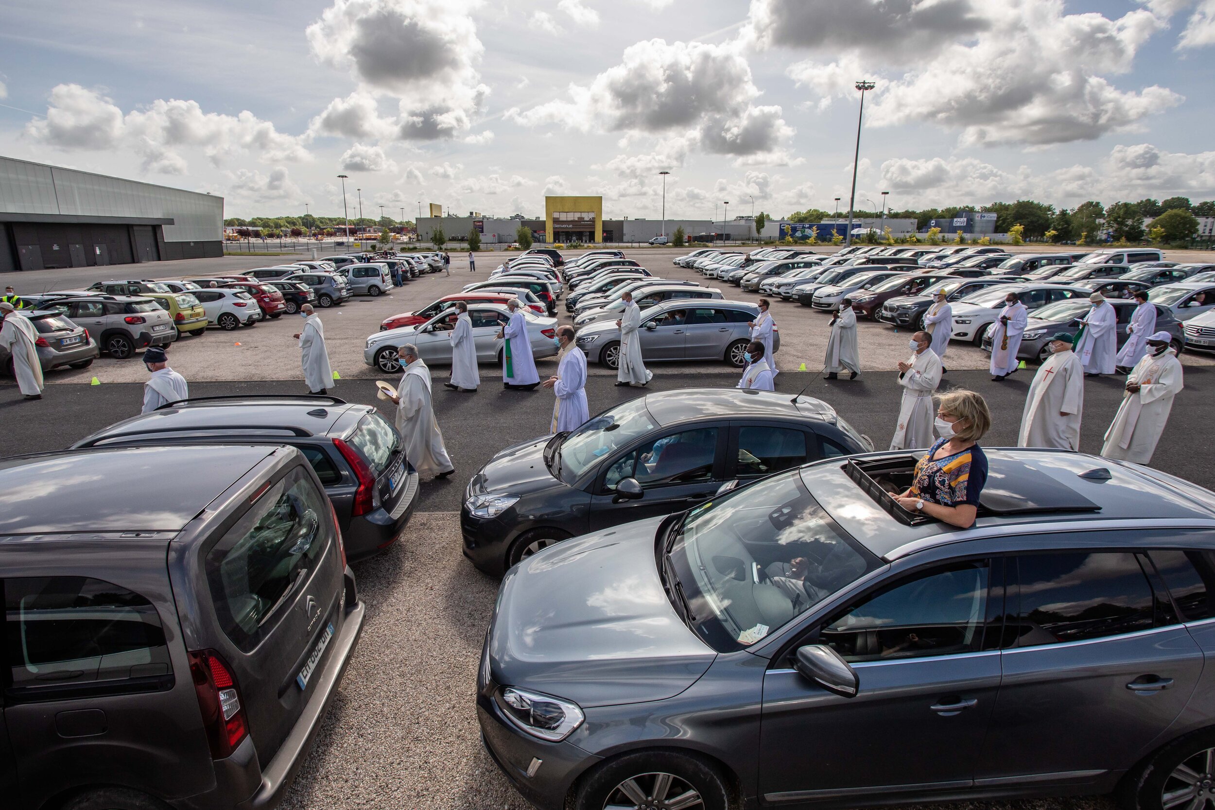   © Aurélien Morissard / IP3; A photo taken on 24 May 2020 shows priests and officiants wearing protective masks during the celebration of the second drive-thru mass in Chalons-en-Champagne, northeastern France.   
