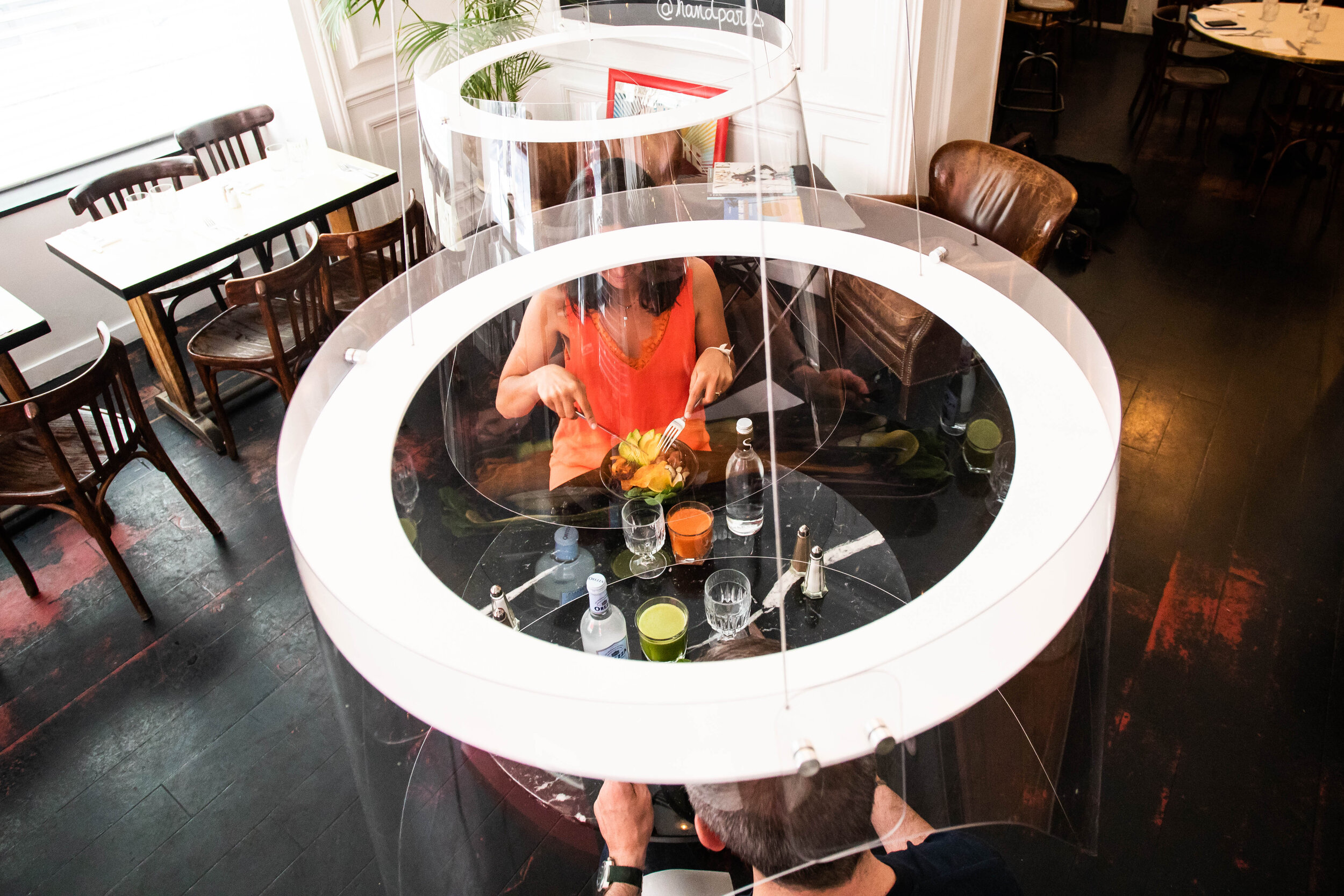   © Alexis Sciard / IP3; Paris, France, May 27, 2020  - Plex Eat is a solution designed by Christophe Gernignon. Plexiglass protective visors are placed over the customers to create a sanitary protection. Here installed in the restaurant HAND Paris. 