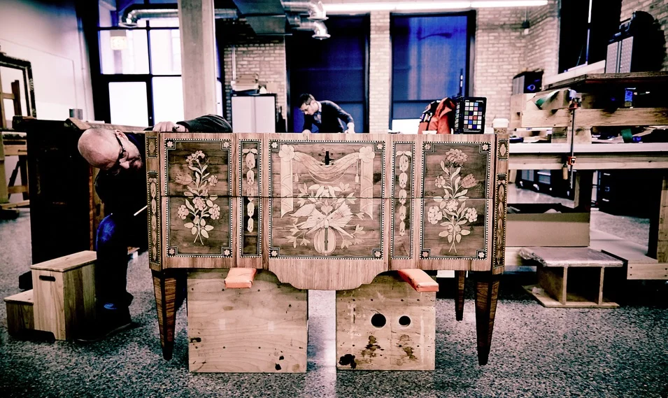 Andrew Rigsby conserving a chest of drawers. Andrew and his colleagues craft historically-accurate tools for their conservation practice.