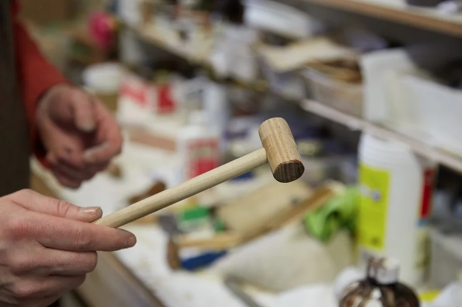 A soft hammer made in-house, used when a regular hammer would potentially dent or damage the surface. It's great for little brass pins and leather.