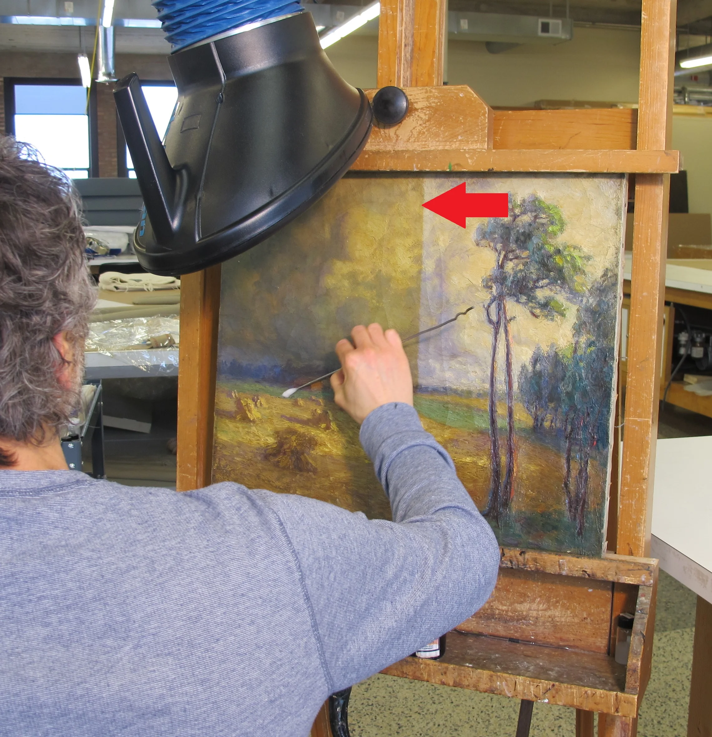 During Treatment - Note the cleaning line at the center of the painting. Associate Paintings Conservator Rob Datum