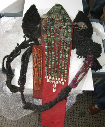 (Above) Before: Ladakhi Headdress made of fabric, felt, yak hair, colored wool, green and coral stones, silver, glue, and skin