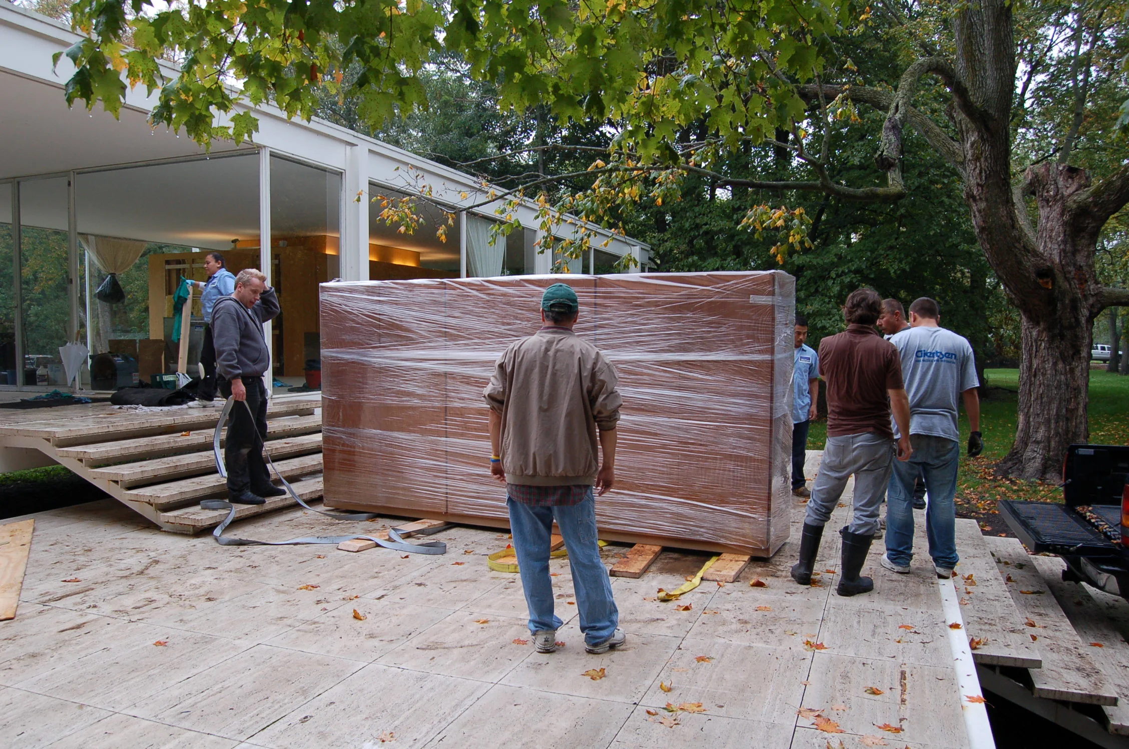 The Conservation Center's team transporting the wardrobe from the Farnsworth House to The Center. The wardrobe suffered severe water damage due to the flood.