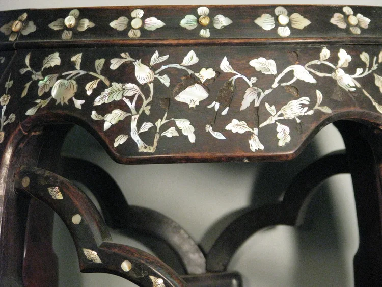 This pre-treatment image of a inlay occasional table clearly shows the recesses where mother-of-pearl fragments had been set. Click here to learn more about the treatment of this table.