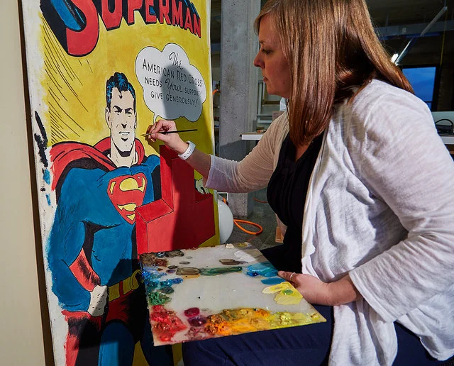 Senior conservator Amber Schabdach in-painting using reversible conservation paints to address the mold stains.