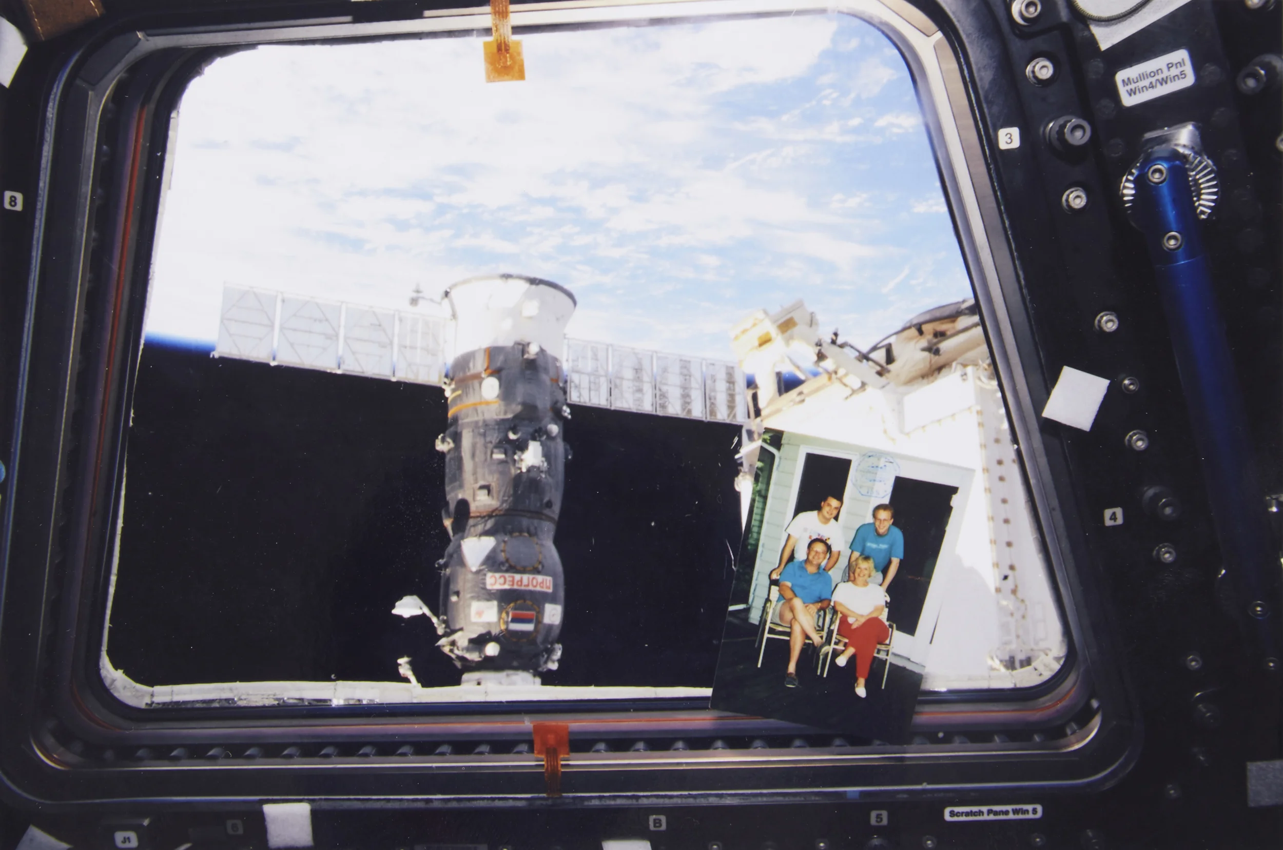 Family photo in the cupola , showing the best view from the International Space Station.