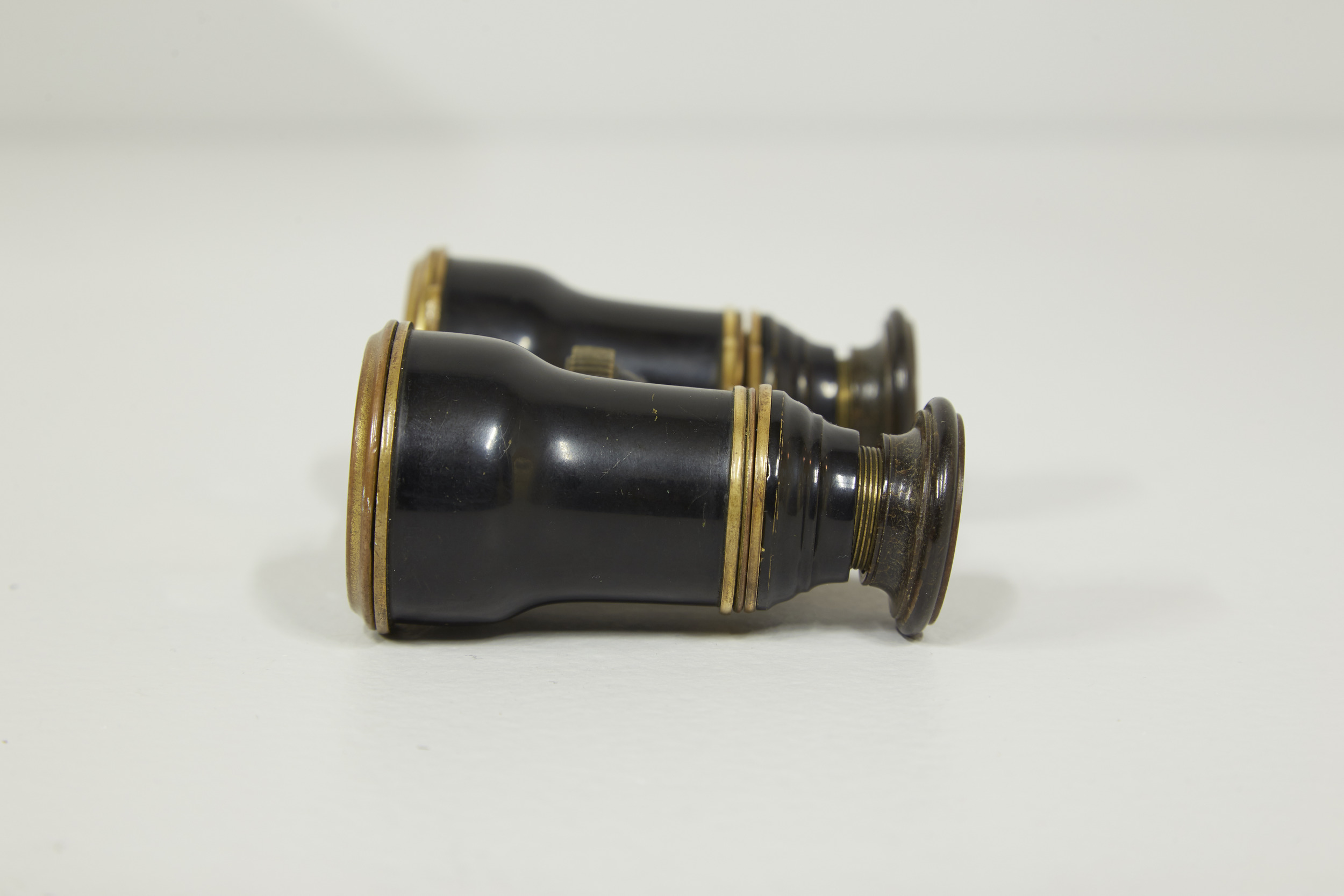 The opera glasses showing the tilted eyepiece, leaving hints the unique history accompanying the binoculars. .