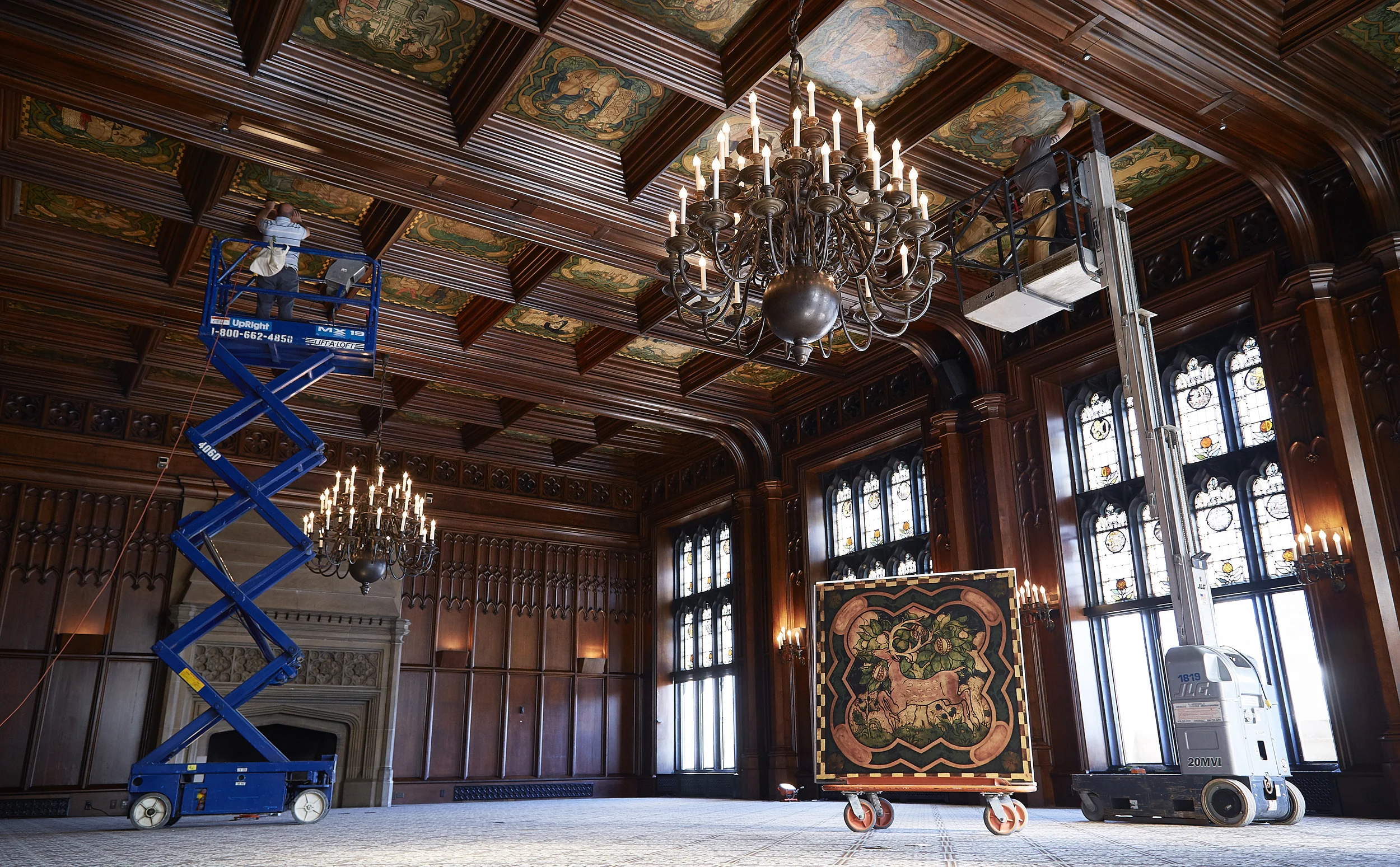 Conservators working on the Michigan Room ceiling mural. 