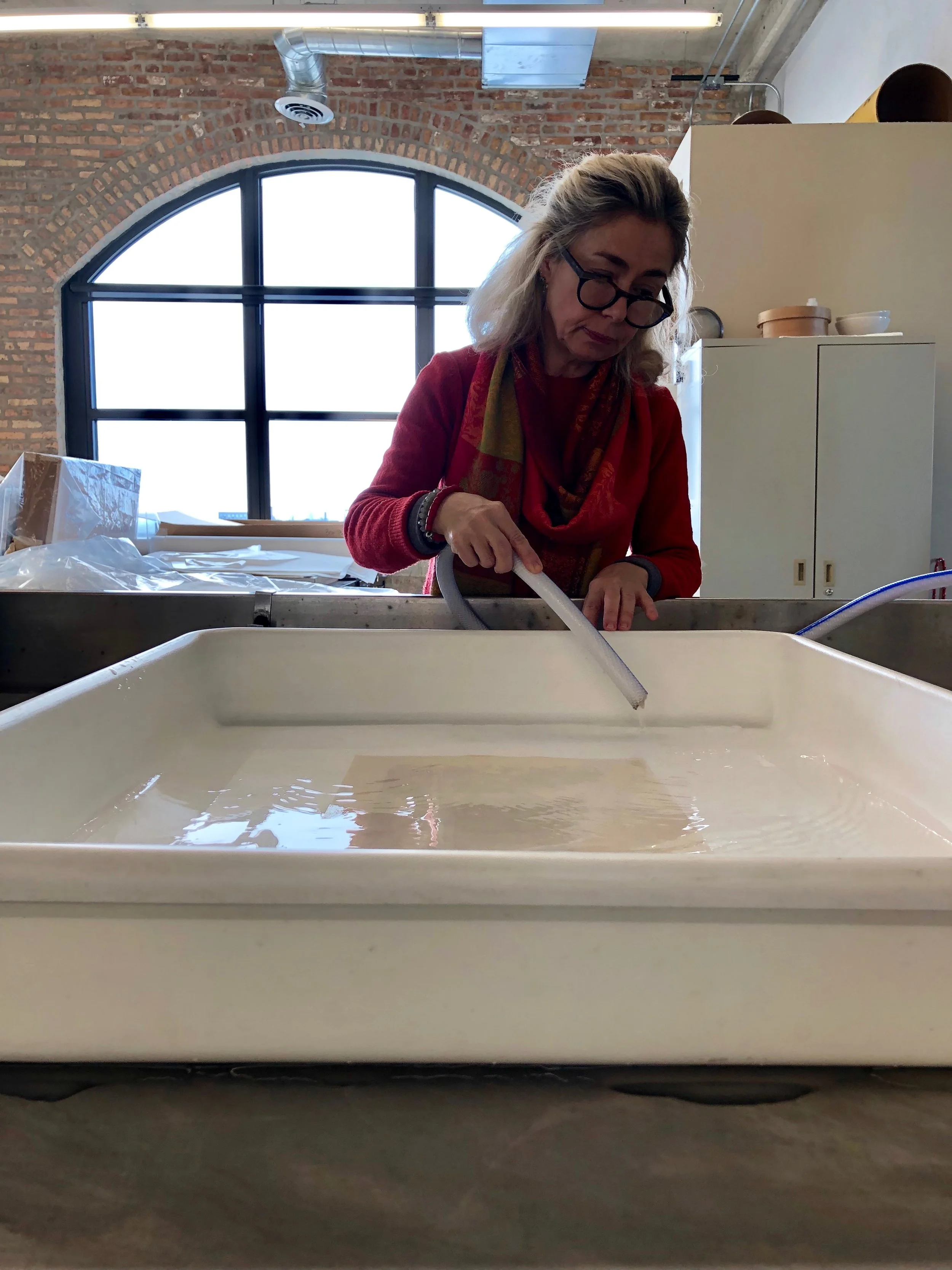 Senior Paper Conservator Bozena Szymanski water washes the print.