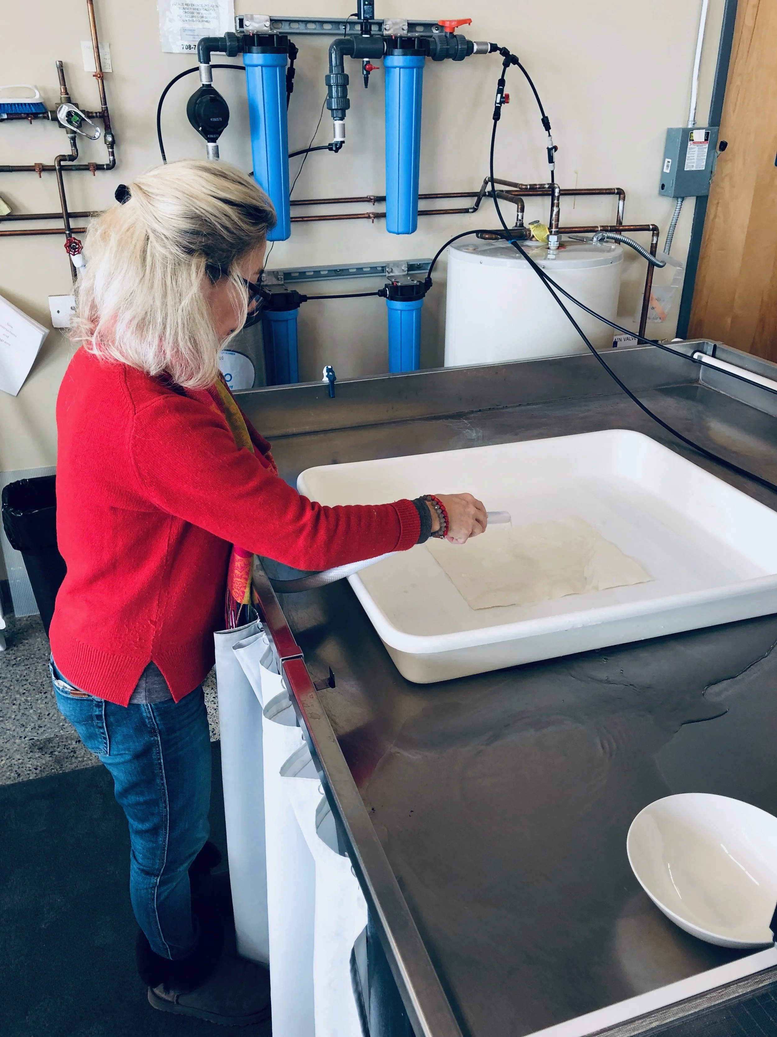 Senior Paper Conservator Bozena Szymanski water washes the print.