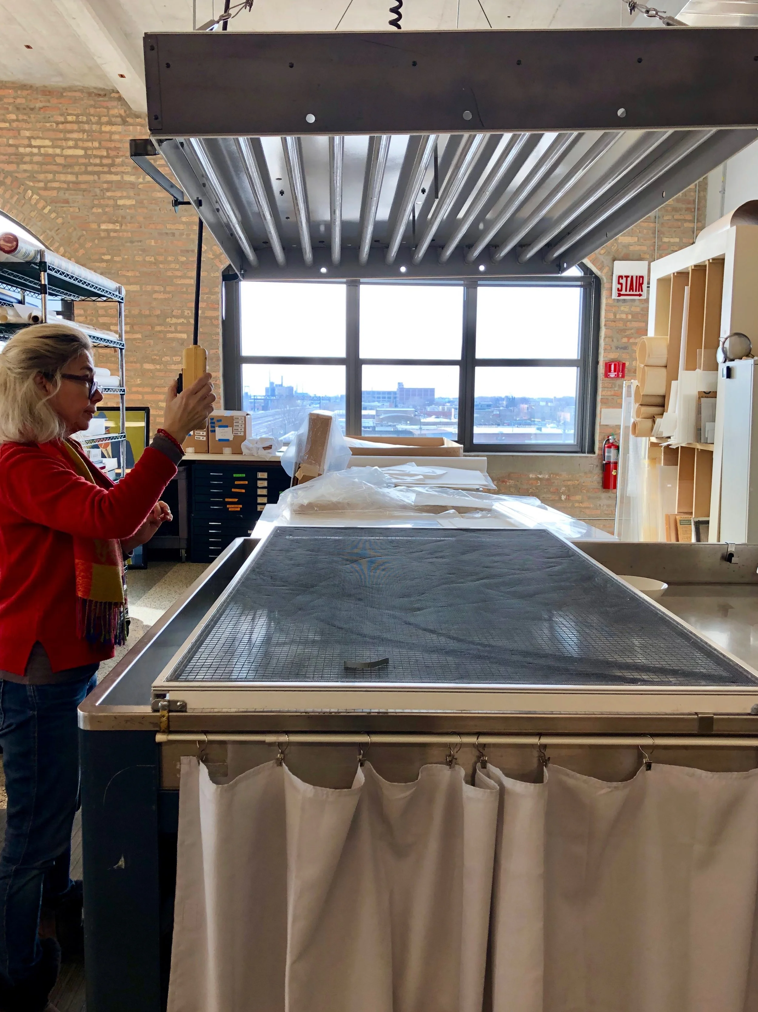 While the print soaks, Bozena prepares the light bleaching station.