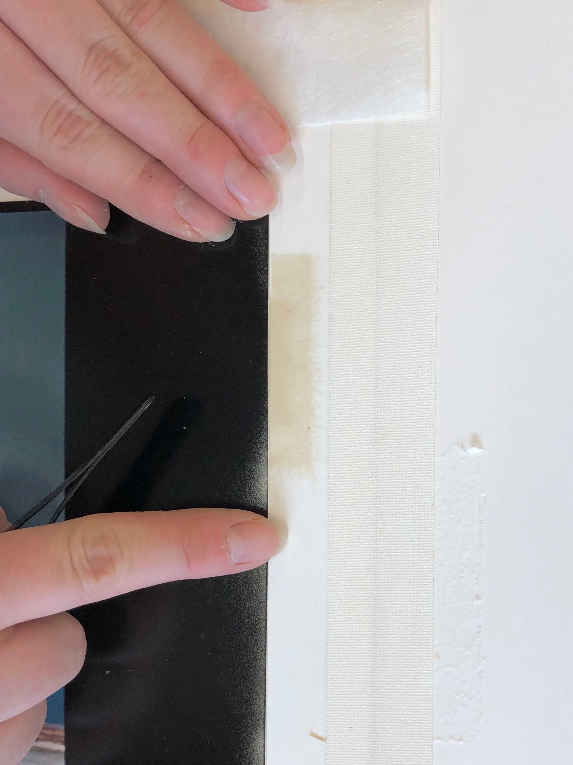 The top part of a T-hinge remains visible until the window mat is added.