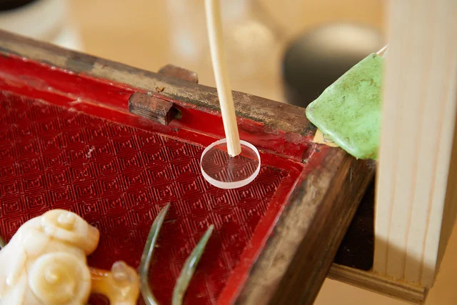 Areas of loss in the red lacquer (cinnabar) were replaced with pigment and resin.