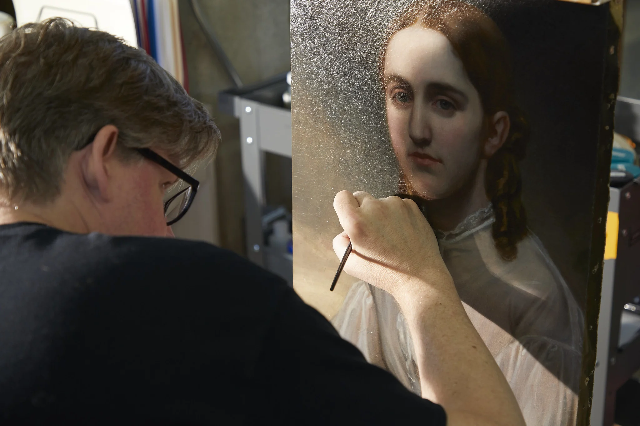 Michael, one of our painting conservators, working on the final details of the treatment.