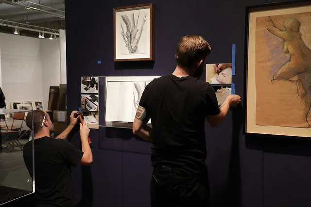 Installing the works at our booth at EXPO.
