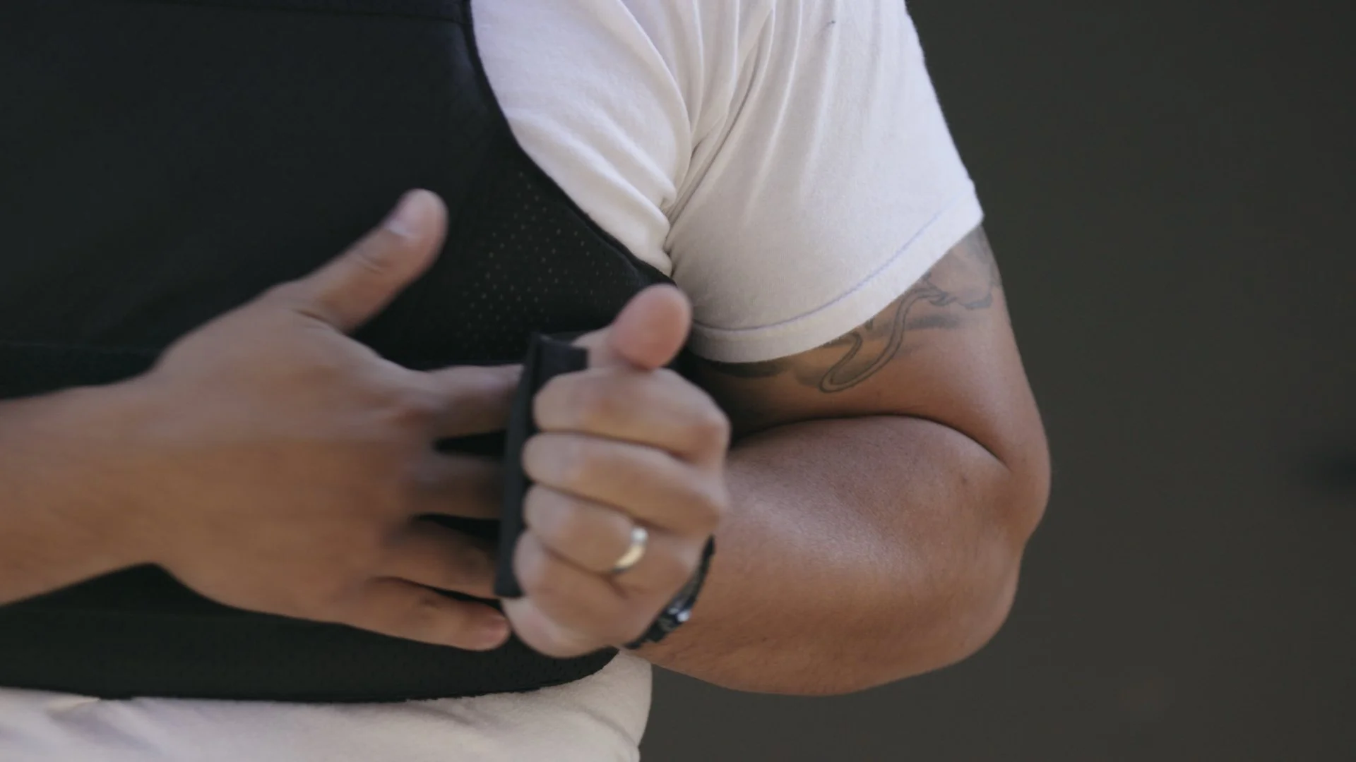 Investigation Discovery Bodycam promo still, an officer pulling on black gloves