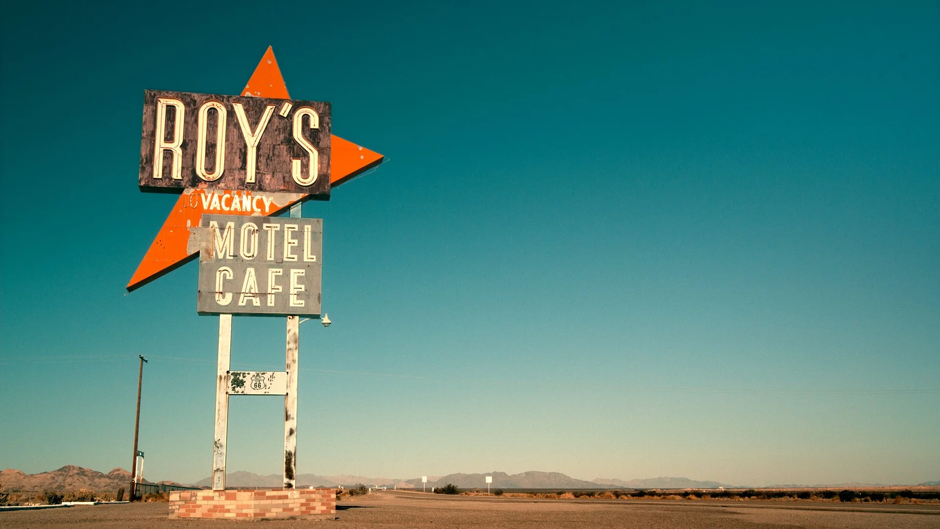 Roy's Motel Cafe sign on Route 66, from Other America, a 12-part documentary series by James Coulson
