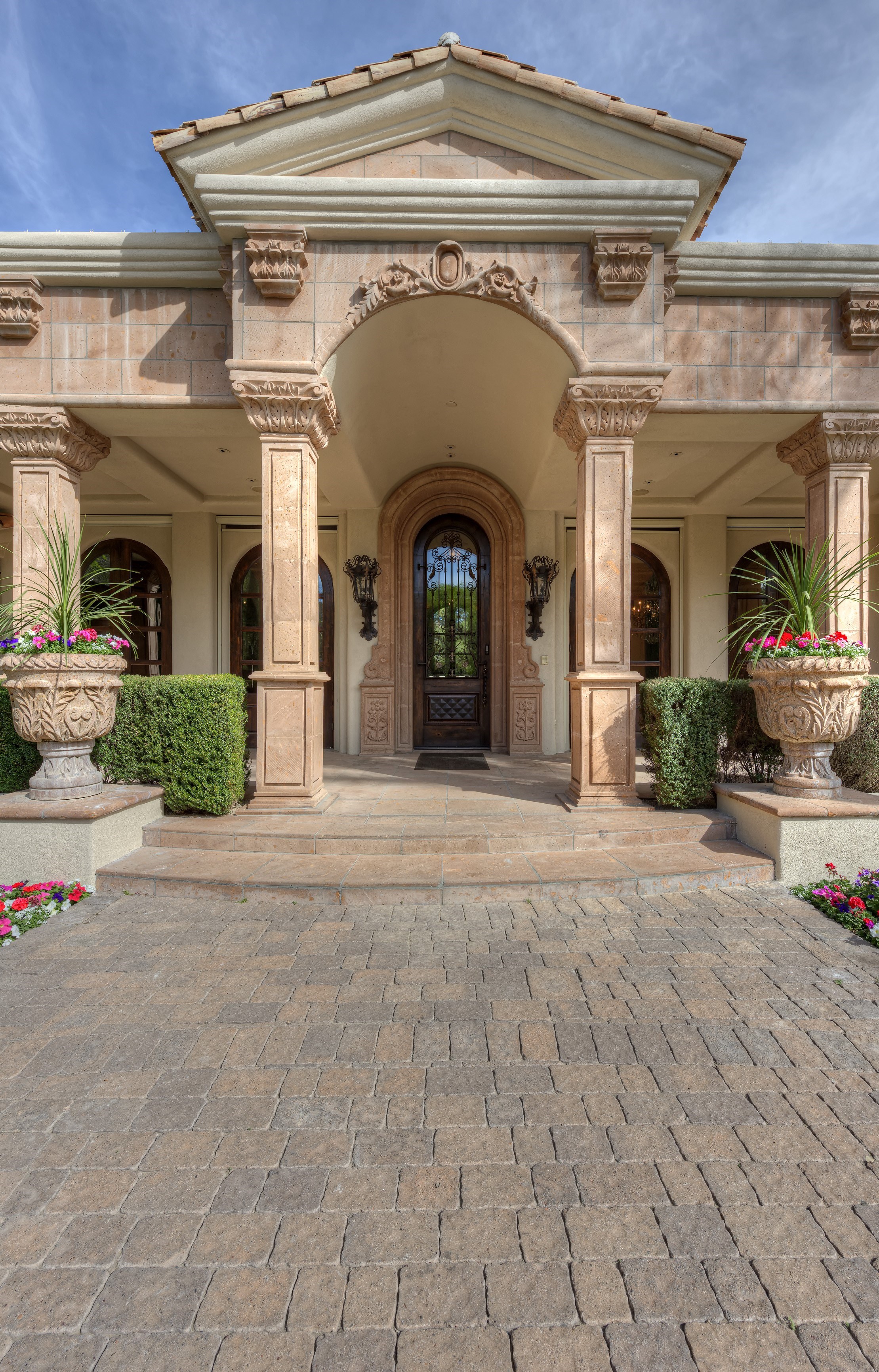 Stunning Portico with Custom Ironwork and Hand-Carved Hardwood Front Door