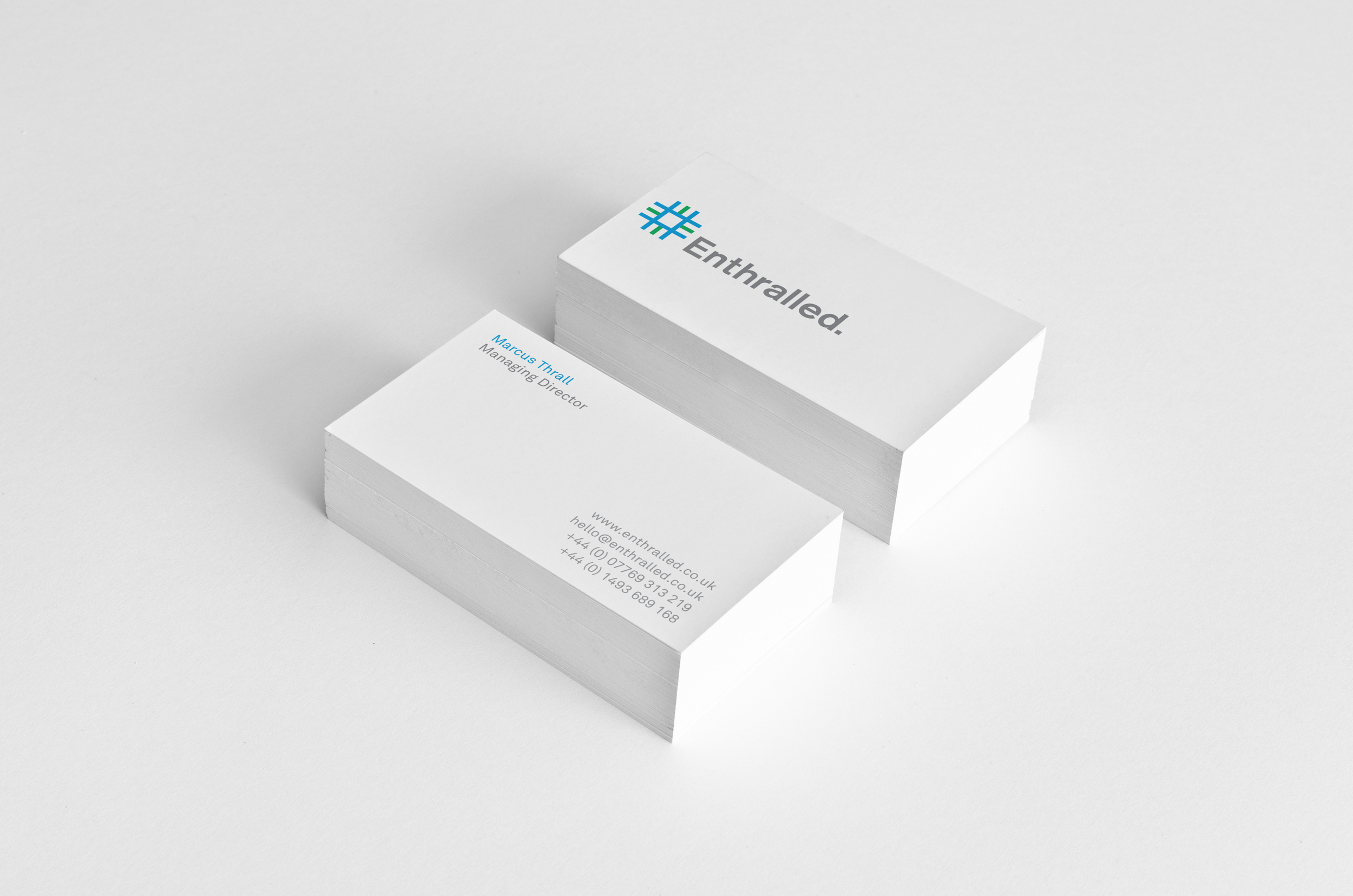 Brand identity designer UK - Two stack of vertical Enthralled white business cards