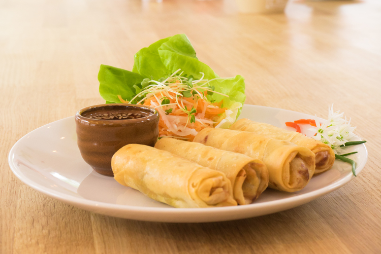 Graphic Design Company UK. A plate of four spring rolls with garnish