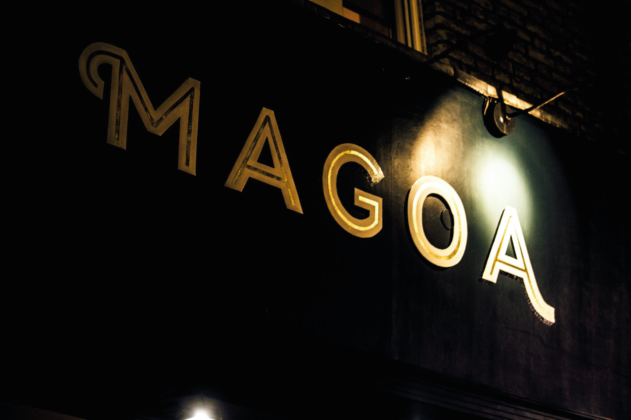 Graphic Designer London. Magoa restaurant sign in black background