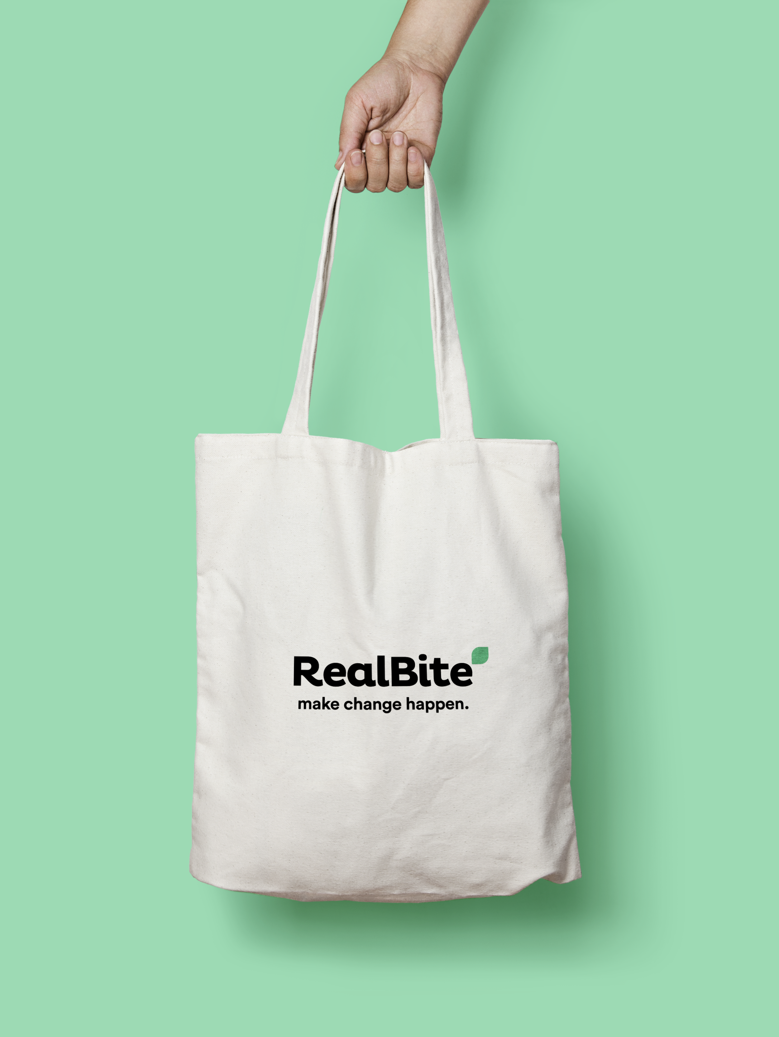 Packaging Designer London - A hand holding a white RealBite branded tote bag