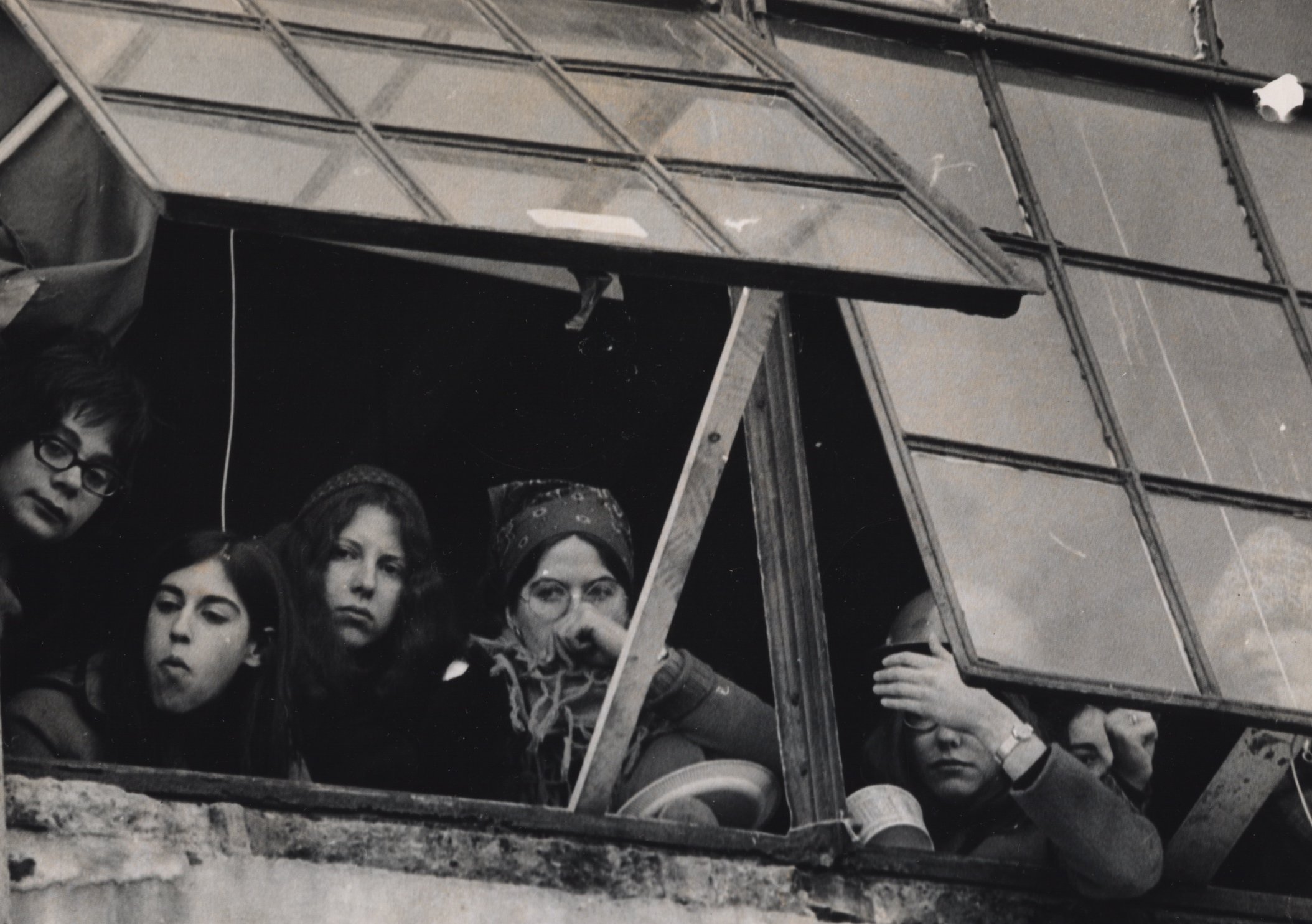 Left on Pearl-Women occupiers anxiously keep watch from window at 888 Memorial Drive.jpg