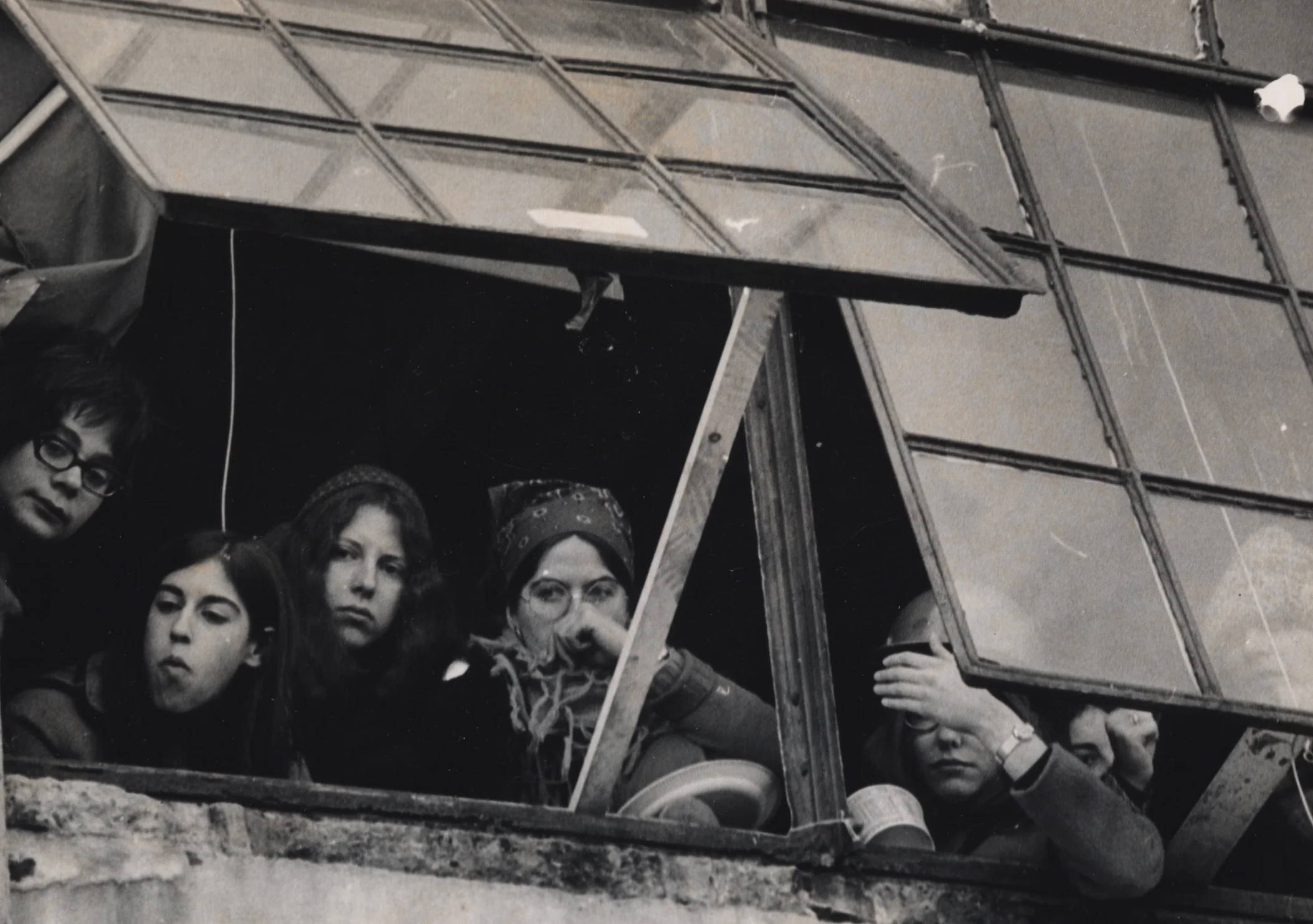 Left on Pearl-Women occupiers anxiously keep watch from window at 888 Memorial Drive.jpg