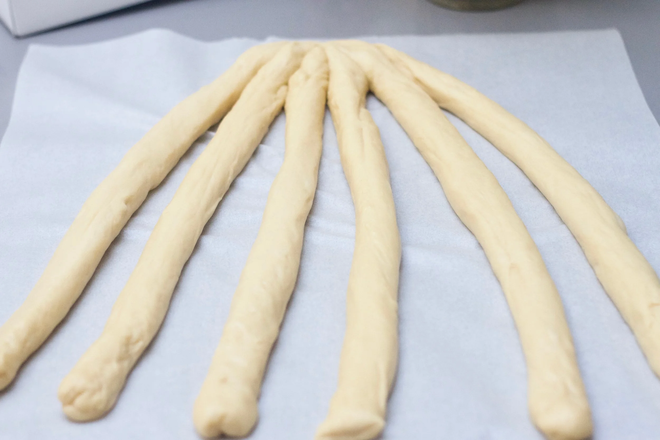 Roll each piece into 6 equal sized ropes and attach at top