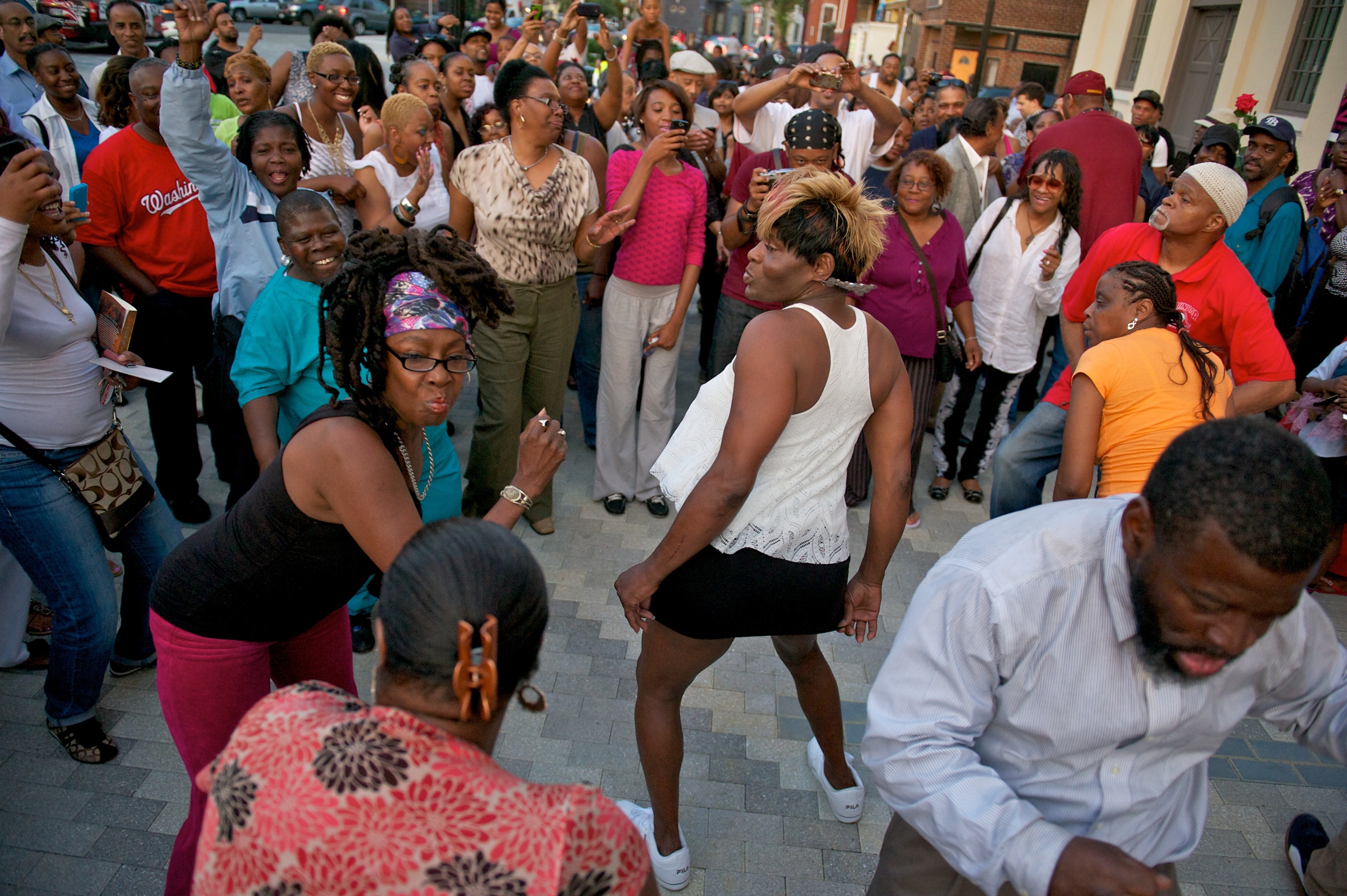   DC residents dance as they celebrate Chuck Brown outside Howard Theatre. A big celebration broke out the night of Chuck Brown's death.(Photo by Marlon Correa/The Washington Pos  )  