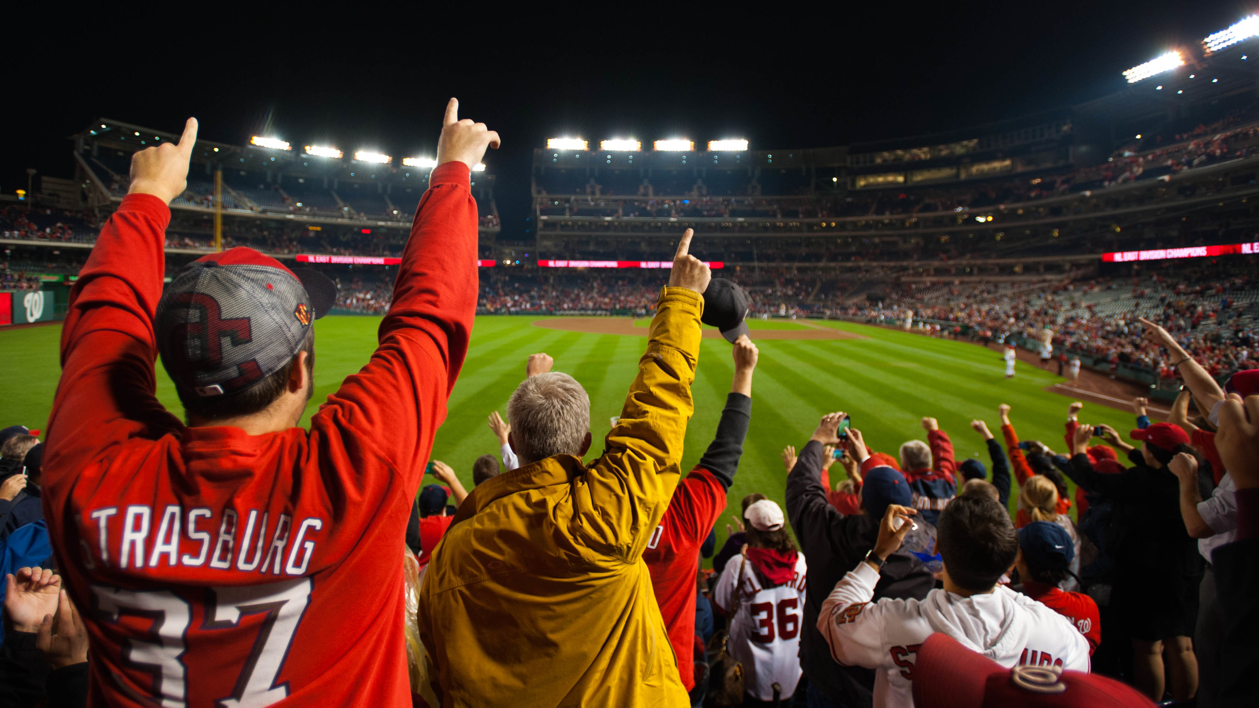  Fans celebrate as the Nationals clinch the division.  (Photo by Marlon Correa/The Washington Post) 