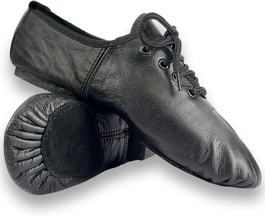 A black ballet shoe made from leather, resting on a matching black leather dance pad.