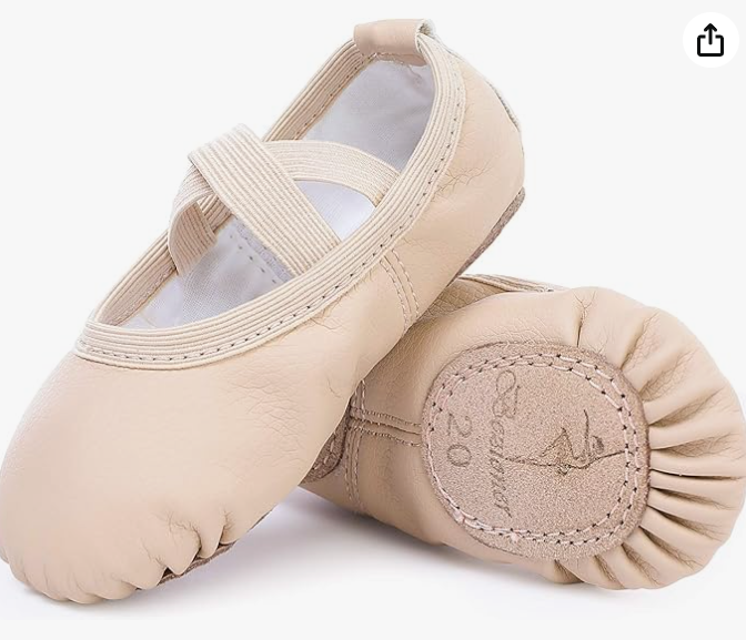 Close-up of light pink ballet slippers with elastic straps and stitching detail.