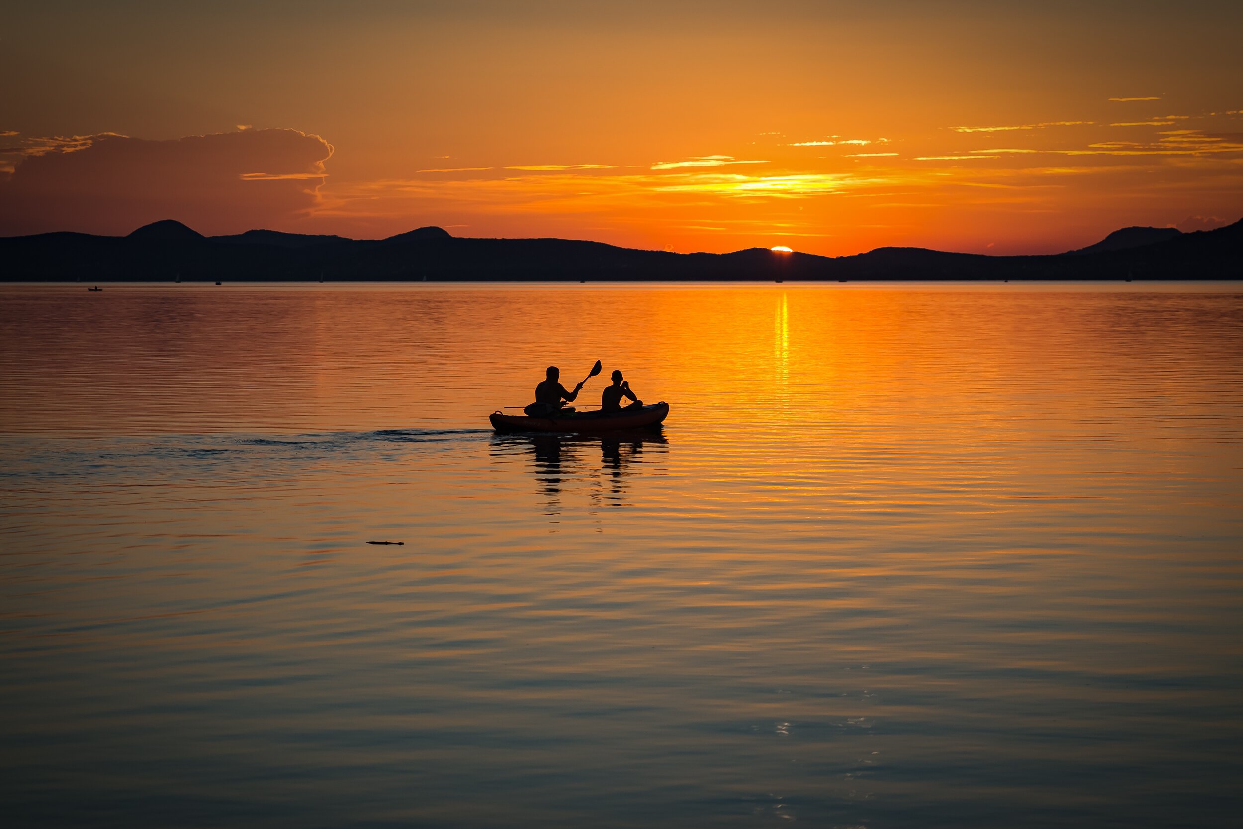 2-person-on-boat-sailing-in-clear-water-during-sunset-158045.jpg