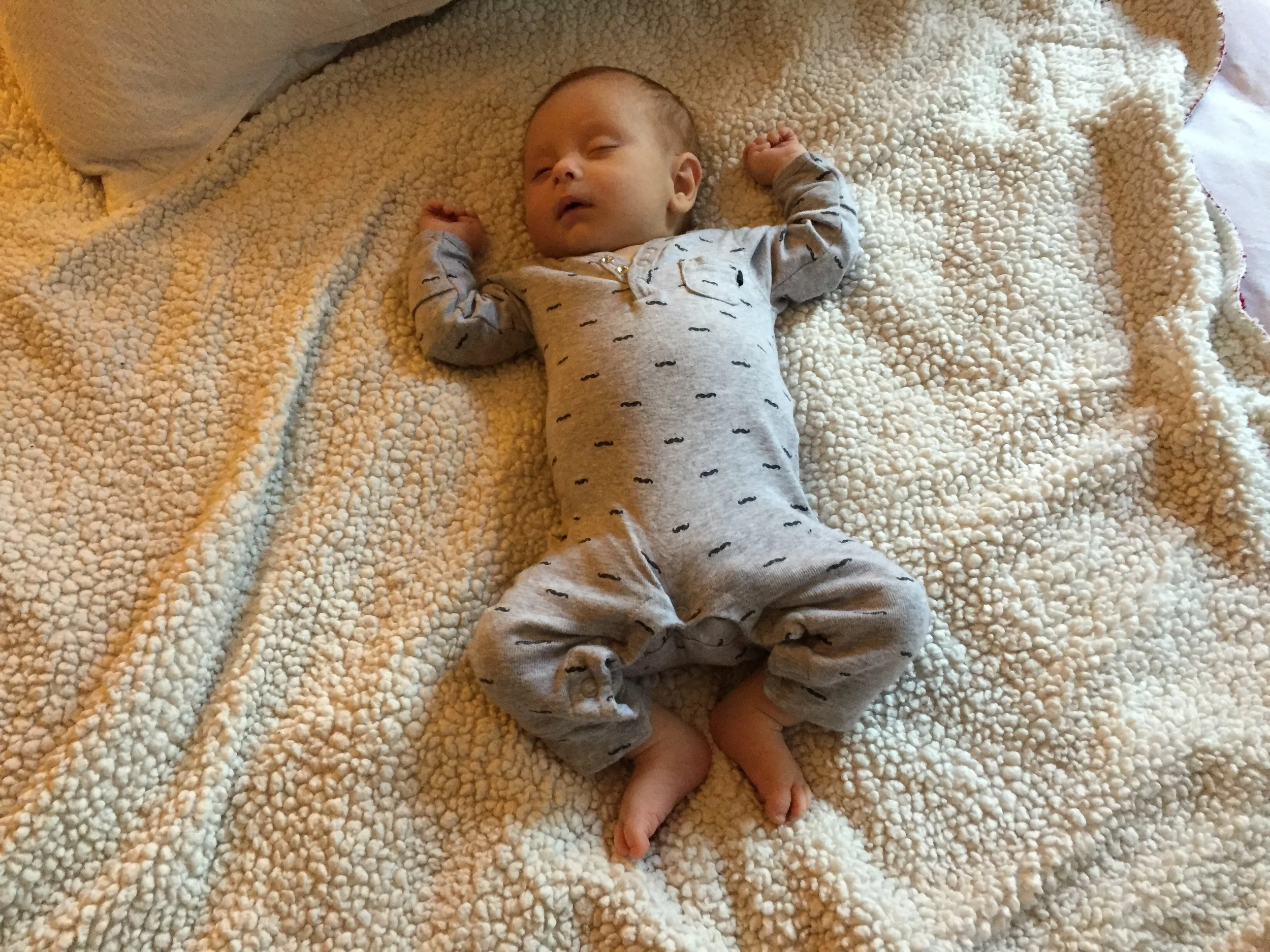 Someone is about to bust out of his newborn clothes