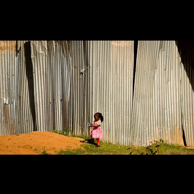 Traveling through the Kenya country side you see all kinds of amazing things. This little girl was playing alongside the road with her toy, a discarded water bottle. And obviously she won the hand-me-down lottery with that fabulous princess dress. S…