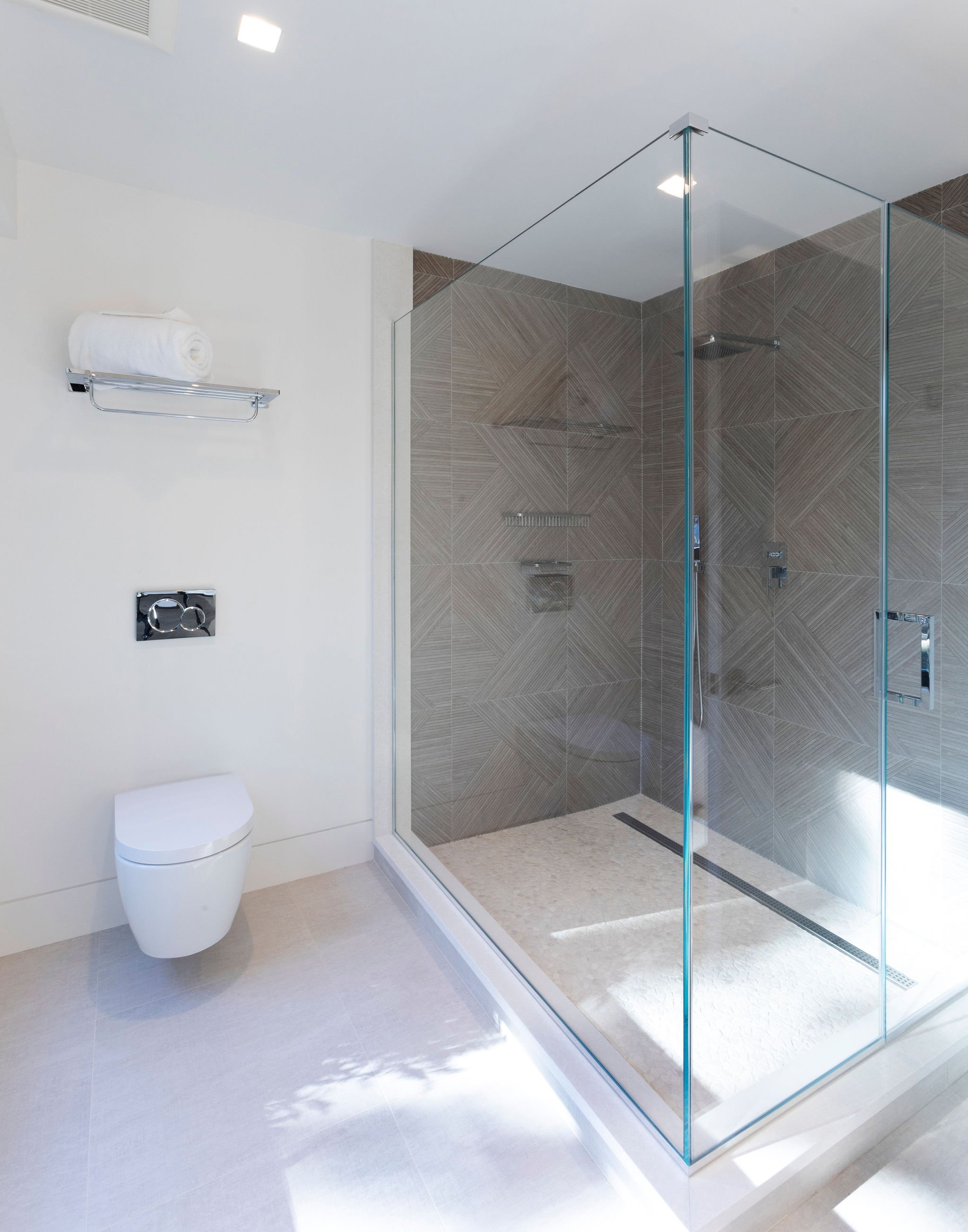  The shower walls are clad with a two dimensional tile that fit together like a puzzle. 